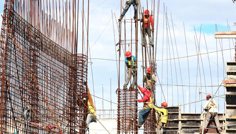 people working on building during daytime