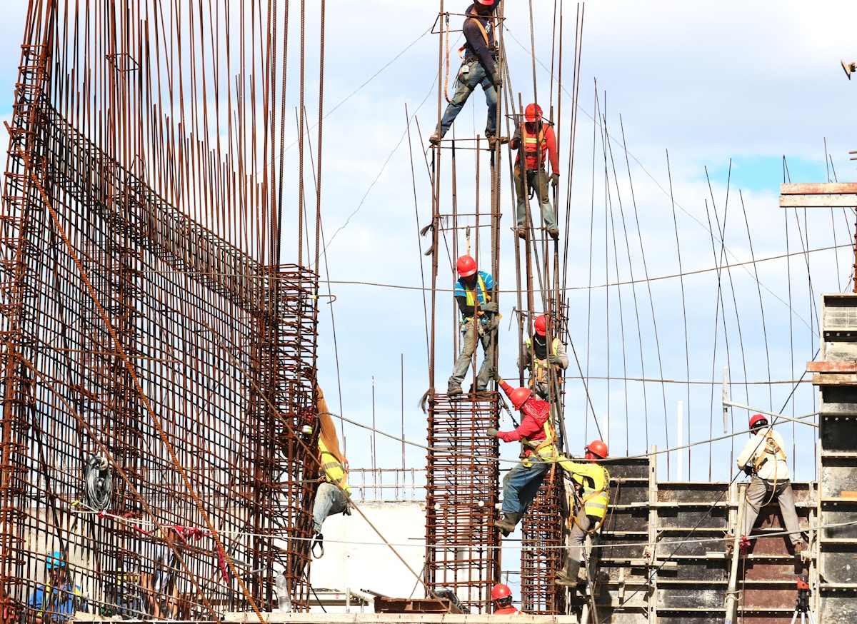 Diverse group of construction workers reviewing safety documentation and site plans