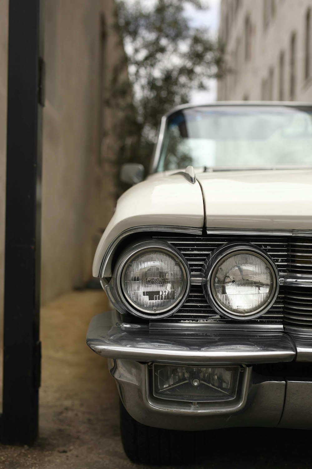 selective focus photography of white vehicle parked between buildings