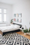 black platform bed with white mattress inside bedroom