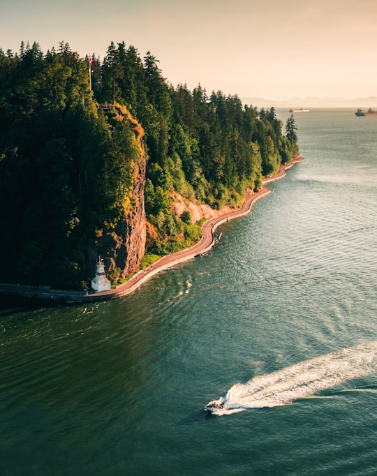 boat on water near cliff in Stanley Park Canada