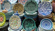 A collection of handmade ceramic plates with artistic patterns.