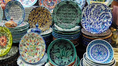 Elegant ceramic plates with traditional Moroccan geometric designs arranged on a rustic table