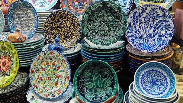 Rows of handcrafted pooja plates decorated with vibrant colors and intricate patterns