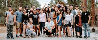 group of people taking photo near brown wooden tree