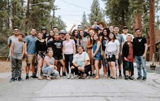 group of people taking photo near brown wooden tree