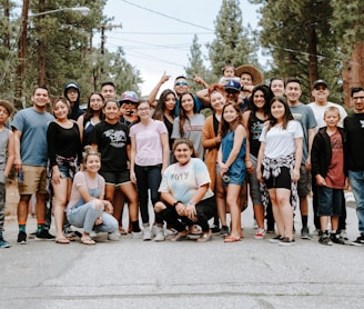 group of people taking photo near brown wooden tree