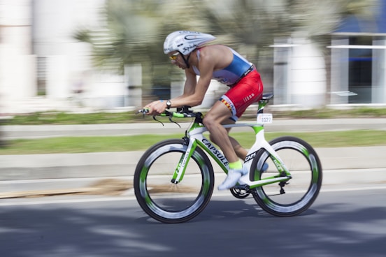 man riding on road bicycle during daytime