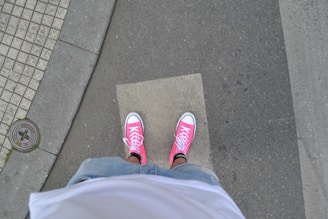 A casual street scene featuring someone wearing bright sneakers.
