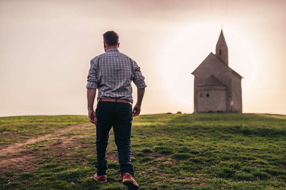 man walking in green grass