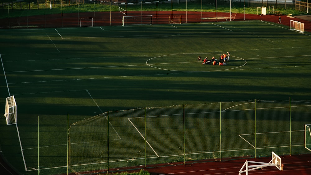 red and black sports car on track field