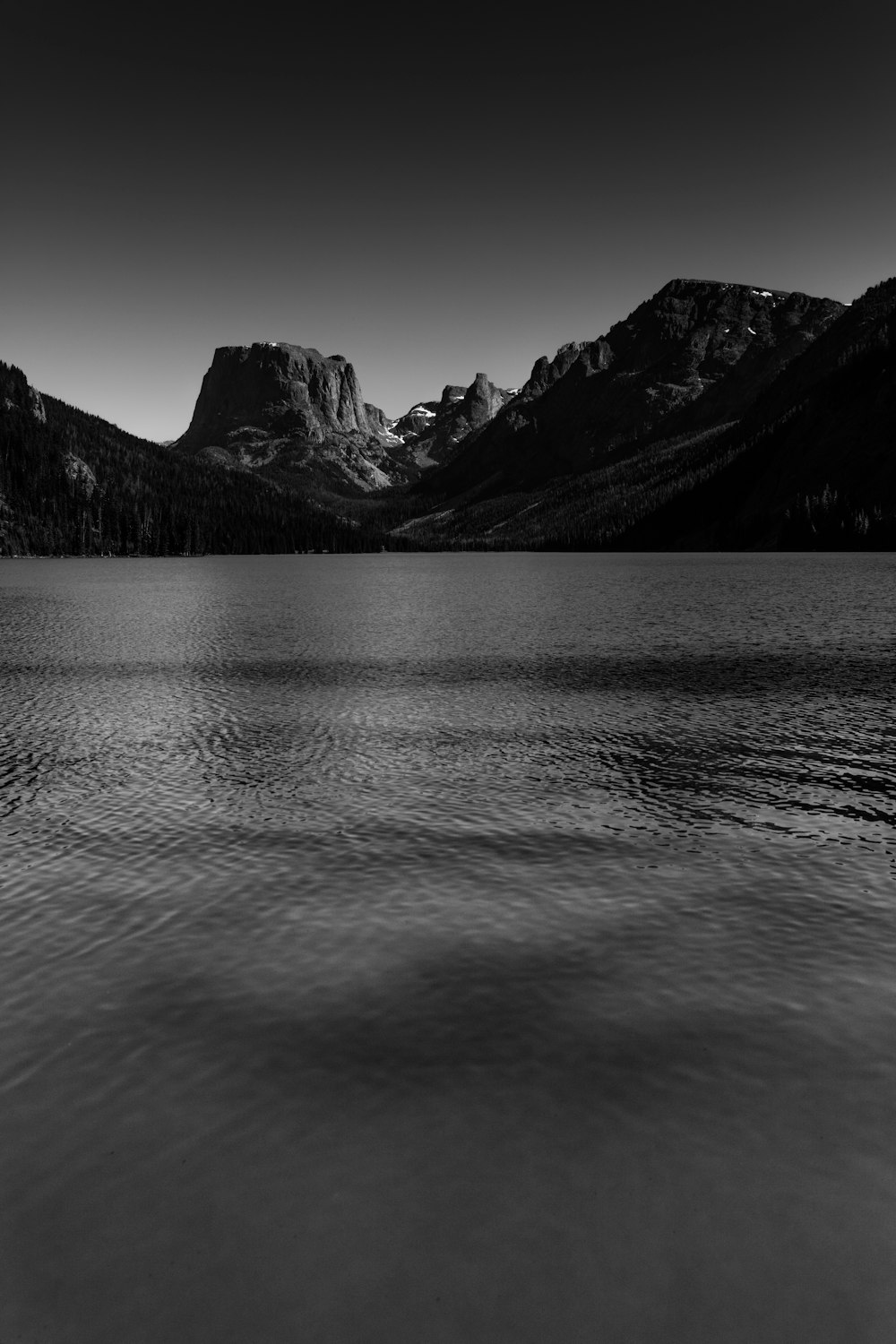 body of water near silhouette of mountain