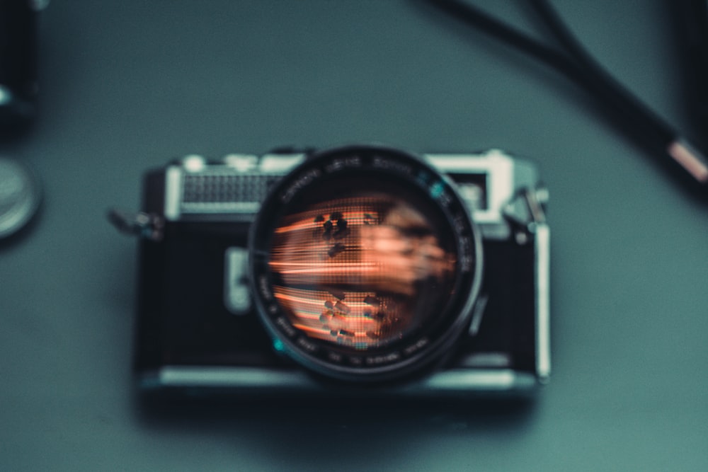 black SLR camera on gray surface