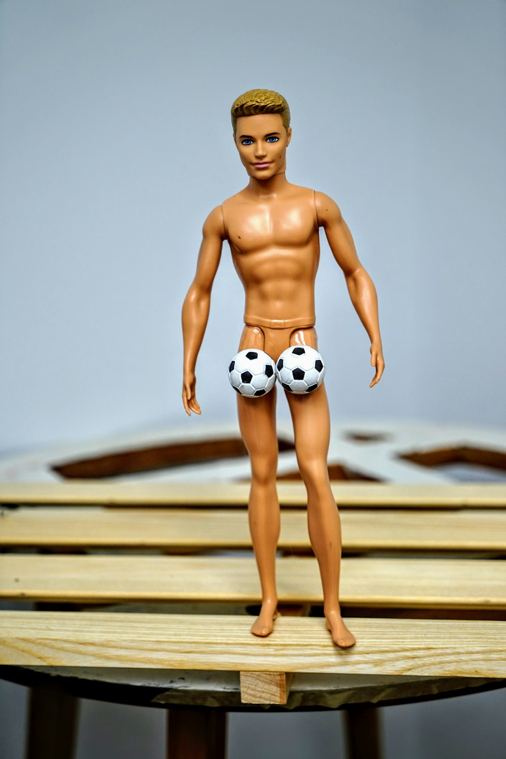 Ken doll on brown surface