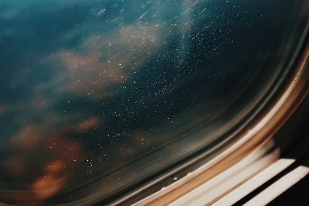 a window with a view of the sky and clouds