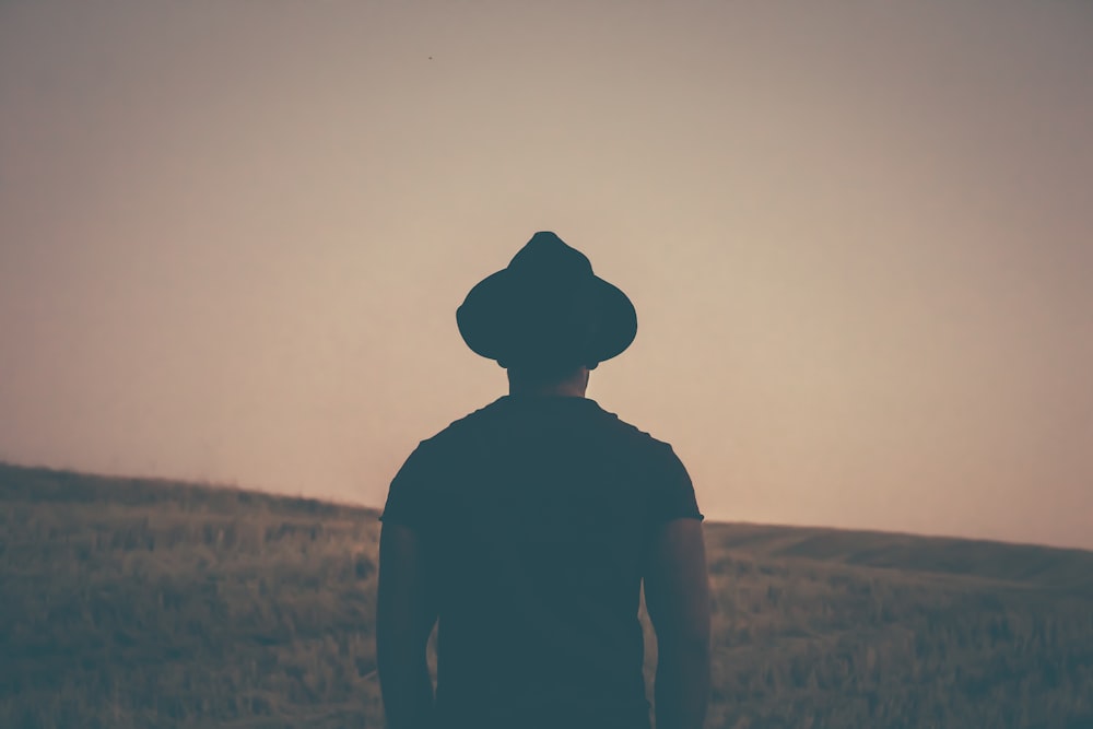 silhouette of person staring at the grass