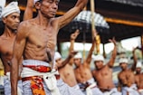 man with knife on stomach raising hands