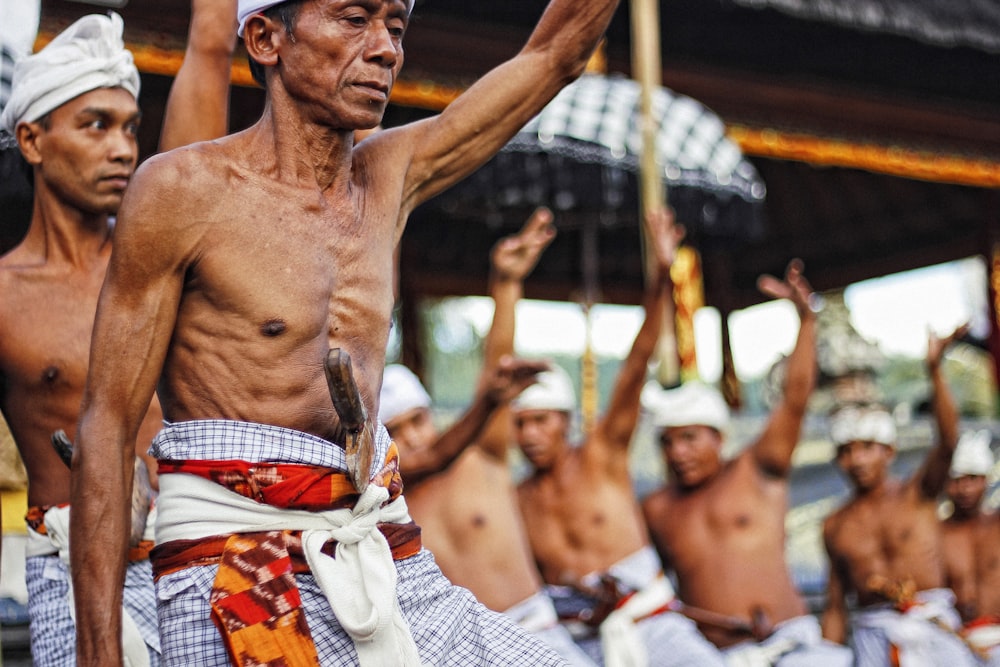 man with knife on stomach raising hands