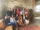 Smiling clients posing naturally against a rustic backdrop inside the studio.