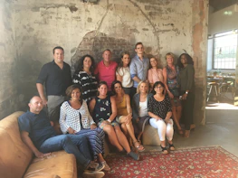 Smiling clients posing naturally against a rustic backdrop inside the studio.