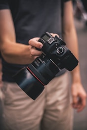 person holding DLSR camera