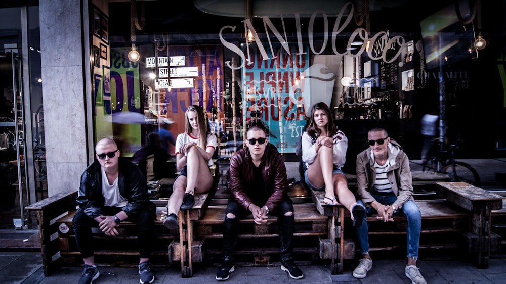 group of people sitting in front of store