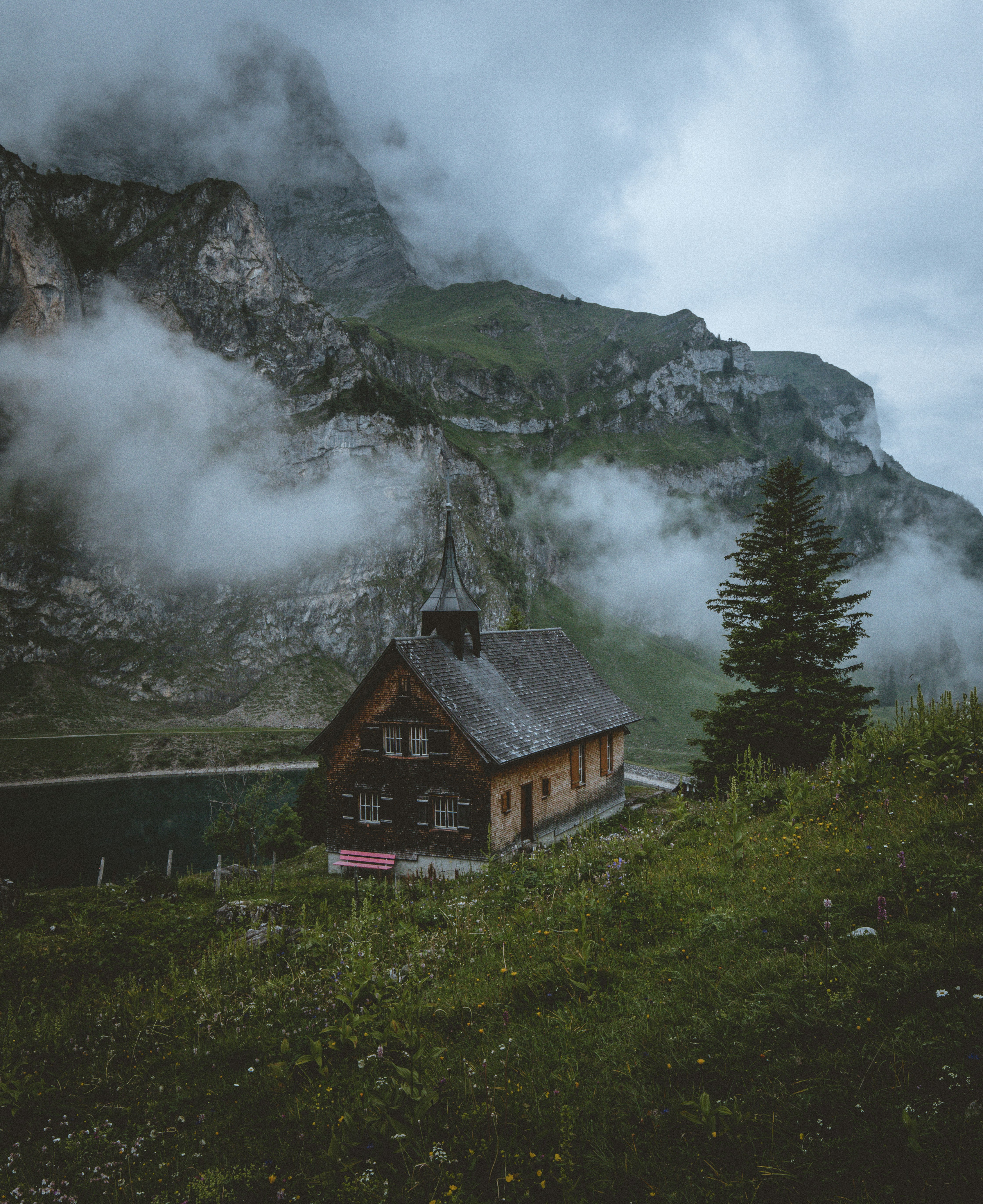 brown and black church beside lake