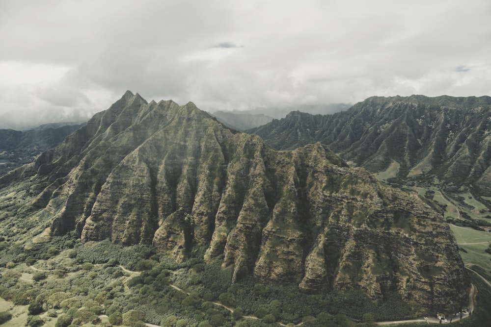 rock mountain under cloudy sky