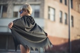 selective focus photography of boy wearing black Batman cape