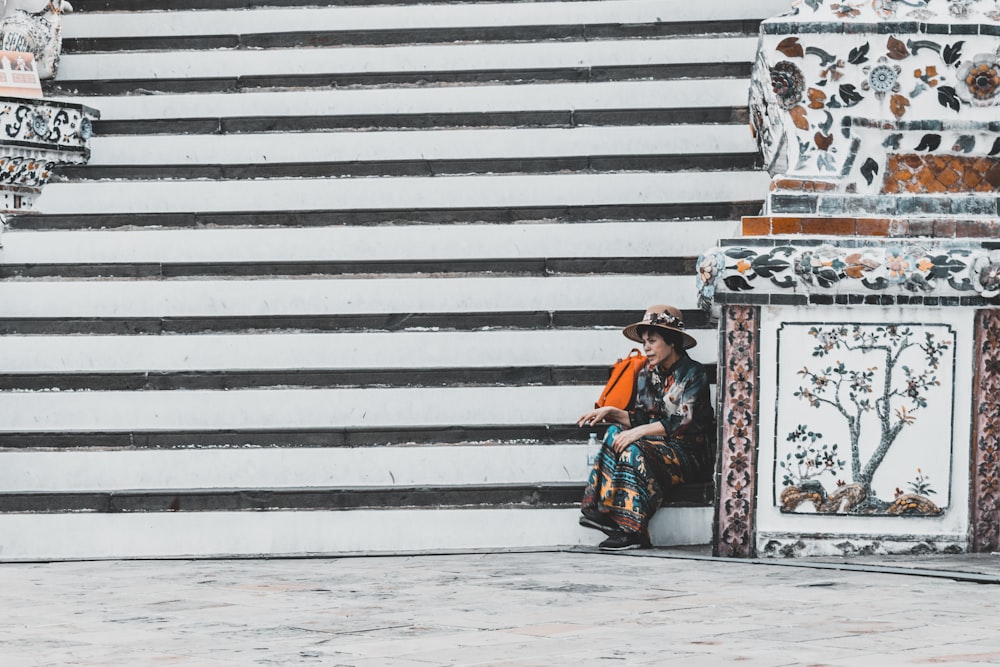 woman sitting on concrete staircase