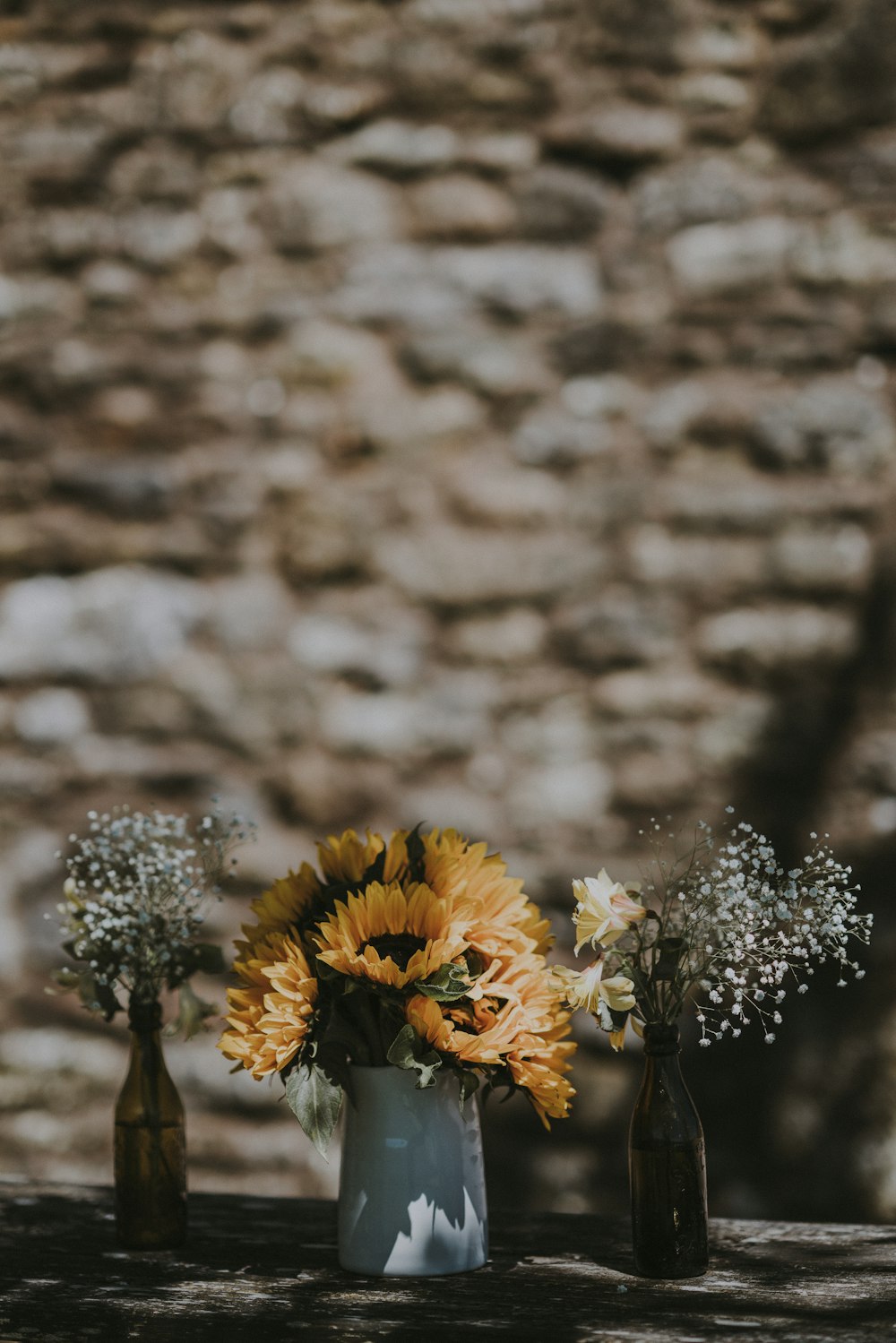 yellow flowers on gray ceramic vase