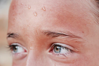Close-up of a determined face with sweat, highlighting mental and physical effort.