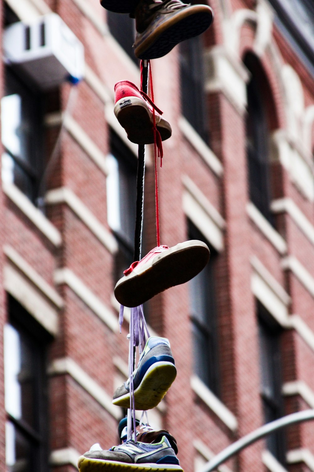 assorted shoes tied up hanging