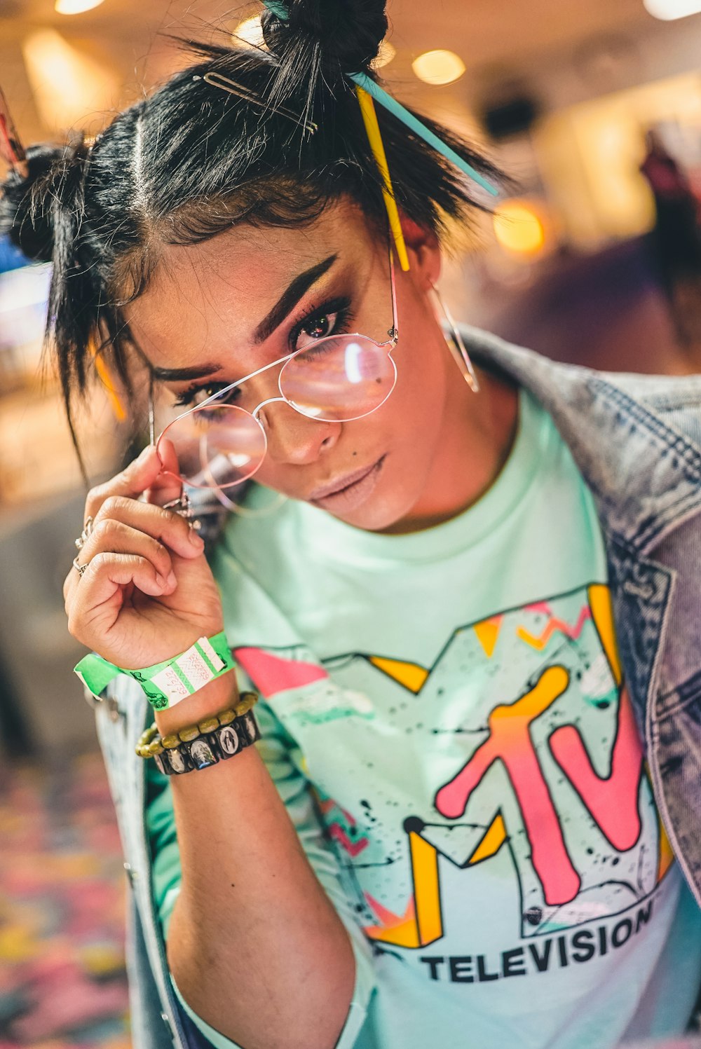 selective focus photography of woman holding eyeglasses