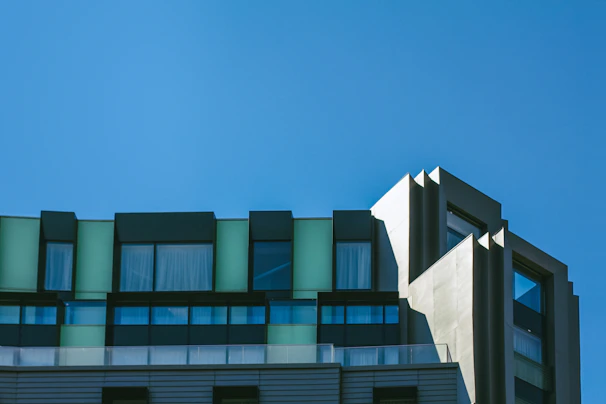 Exterior view of a newly constructed modern building under bright sunlight.
