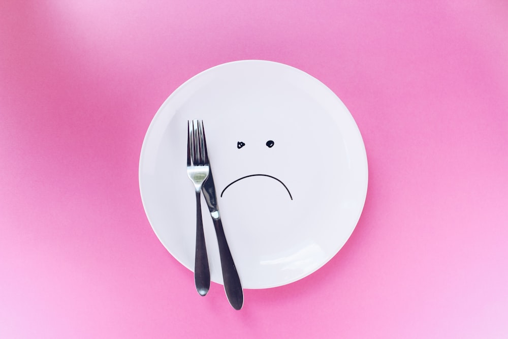 silver fork and knife on plate