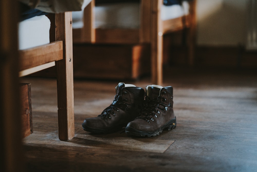 brown boots on floor beside chair