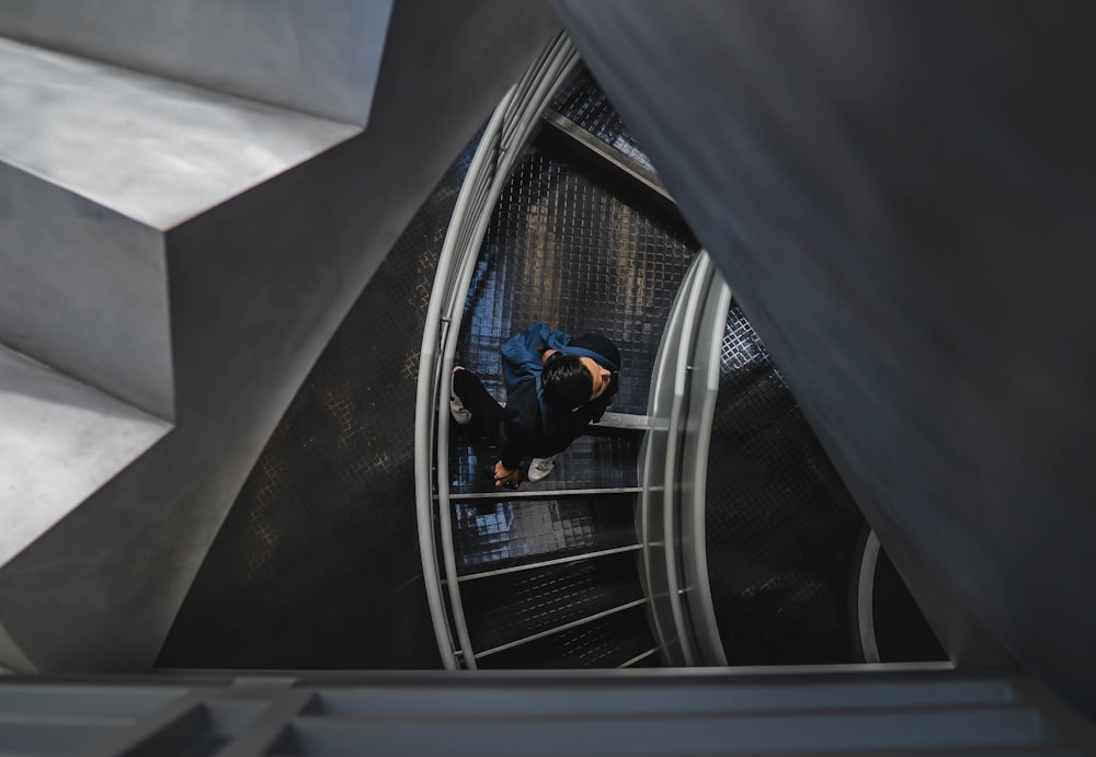 man walking on spiral stairs