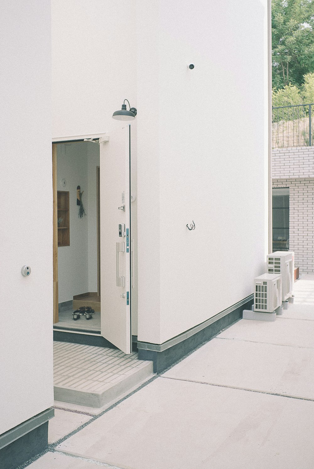 Bâtiment en béton blanc avec porte ouverte le jour