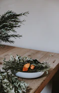 Close-up of natural herbs and flowers arranged on a wooden table