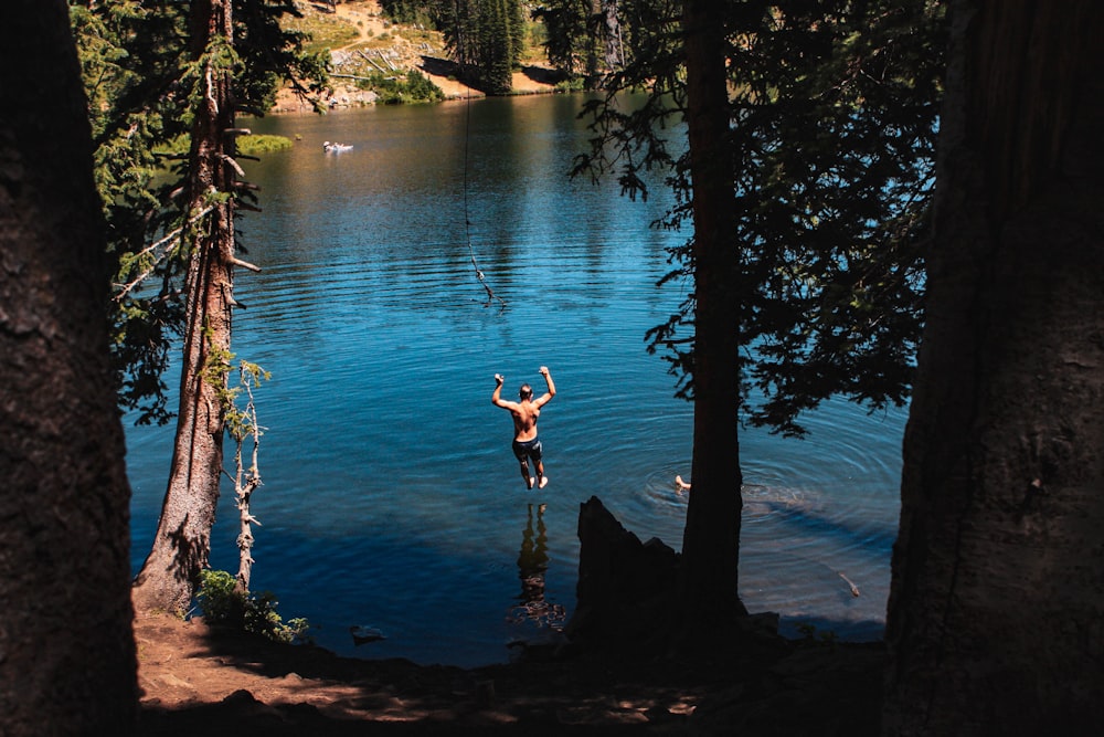 man jump into river at daytime