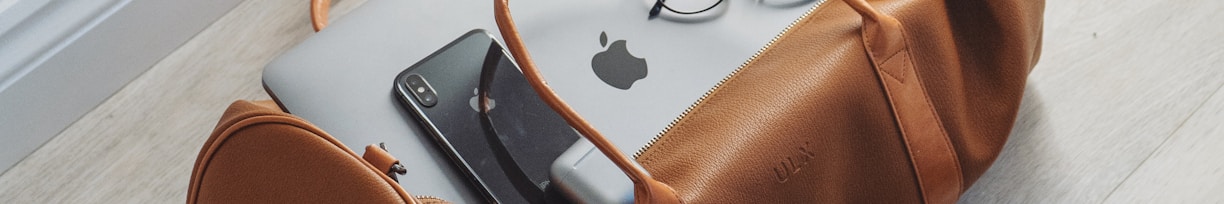 silver MacBook in duffel bag