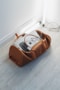 silver MacBook in duffel bag