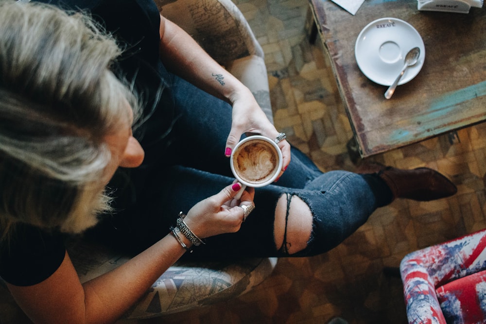 woman sitting on chair having her coffee