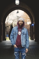 Casual streetwear look featuring layered hoodies and distressed jeans, shot in soft natural light.