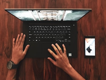 person holding black laptop computer