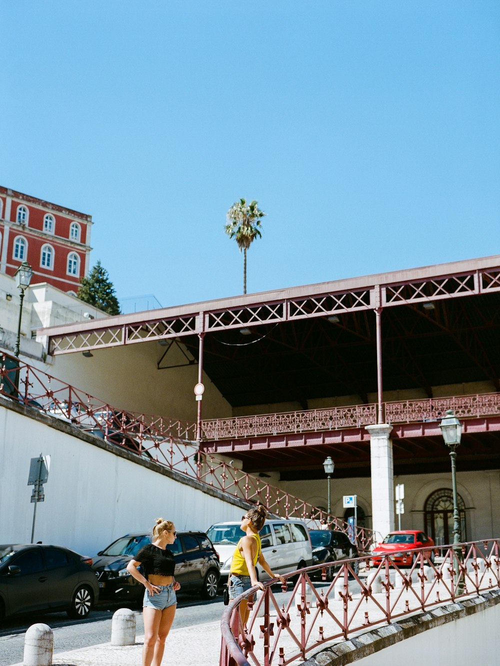 two women standing near cars