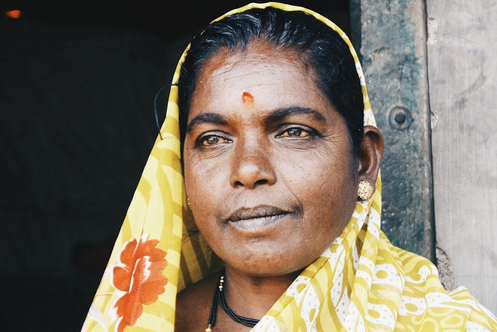 woman standing beside gray and green wall