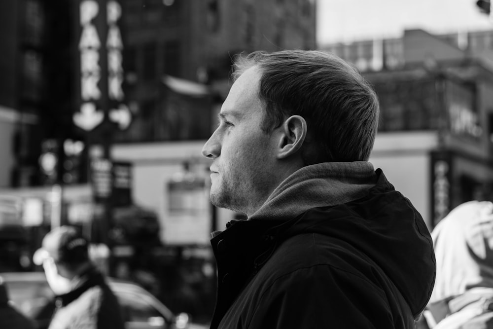 greyscale photography of man looking far away