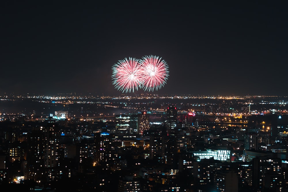 city building under fireworks during nighttime